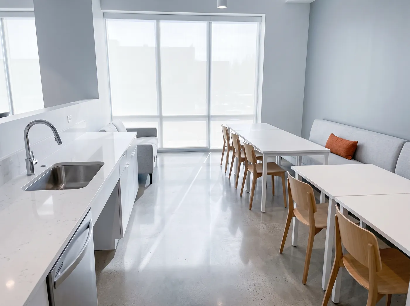 A clean office break room with wiped counters and tidy tables